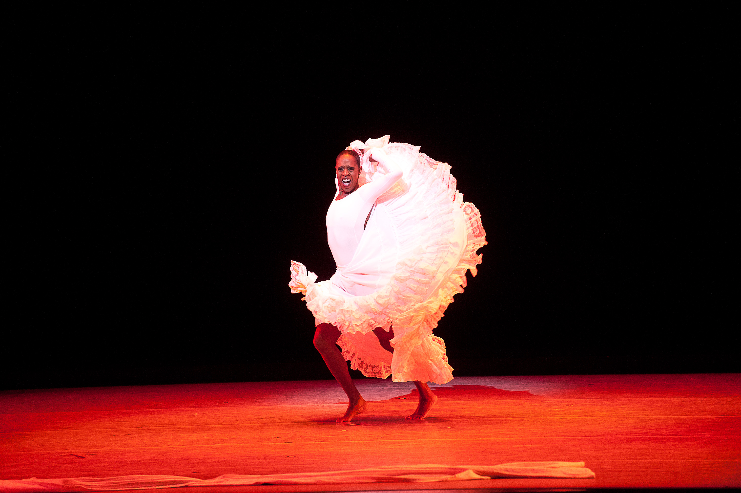 Nasha Thomas dancing Alvin Ailey’s Cry in a white leotard and long ruffled skirt