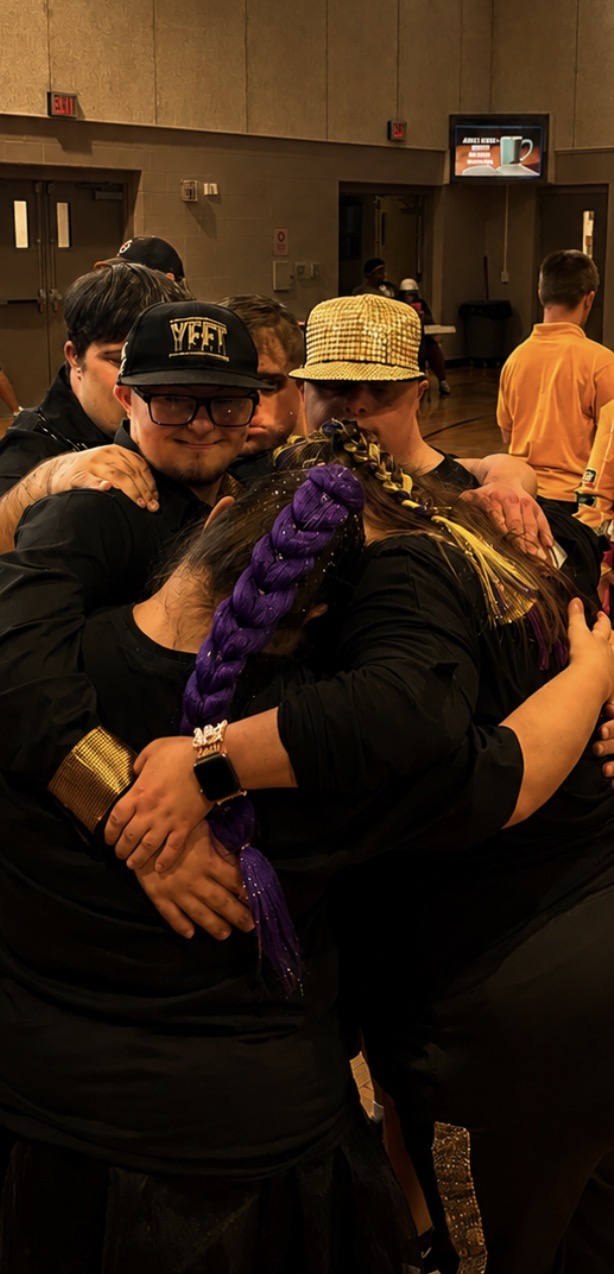 Solo Expression community sharing a group hug during the fifth-anniversary celebration