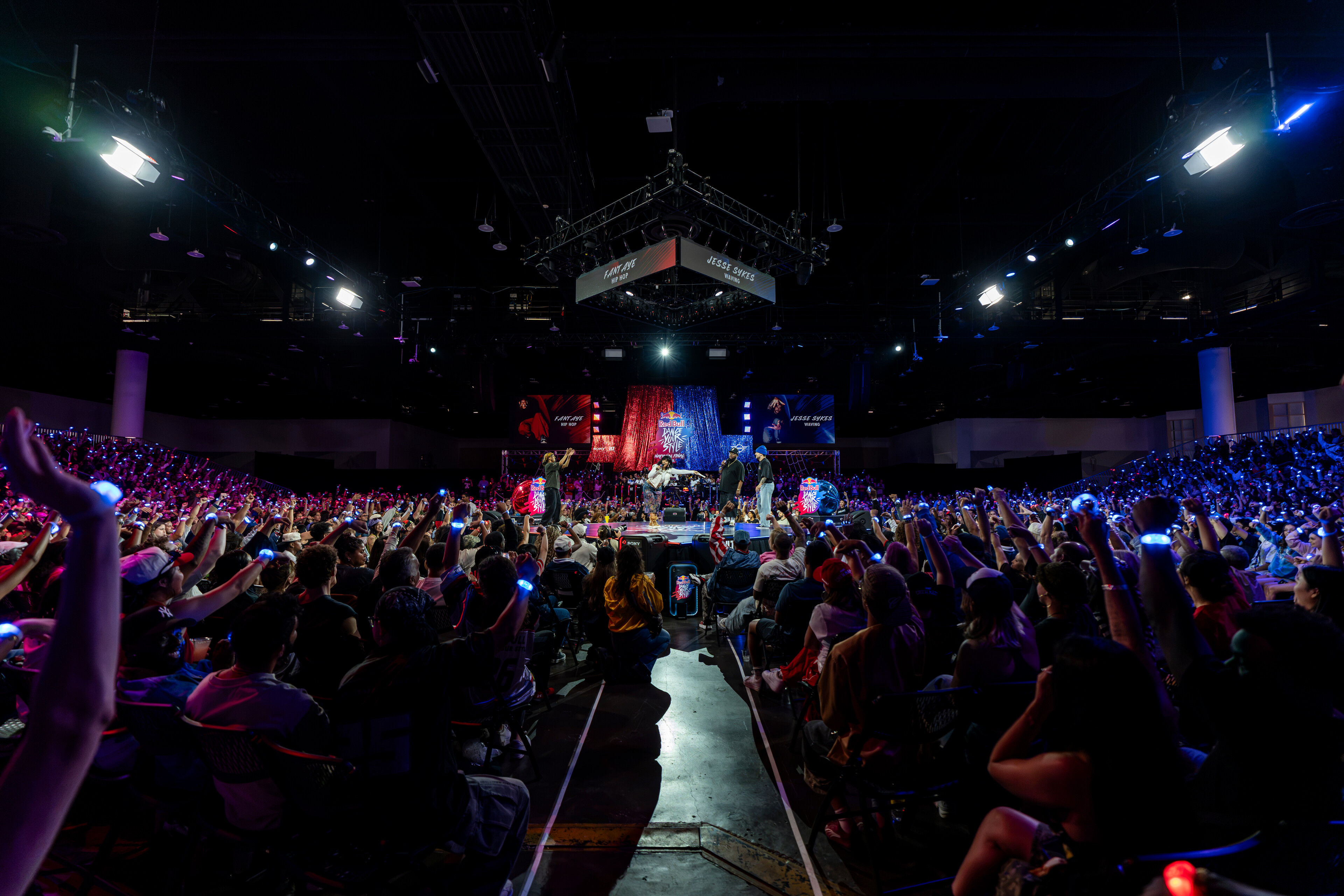 The crowd at the 2026 Red Bull Dance Your Style USA National Final raises illuminated voting wands during a battle at the Tampa Convention Center
