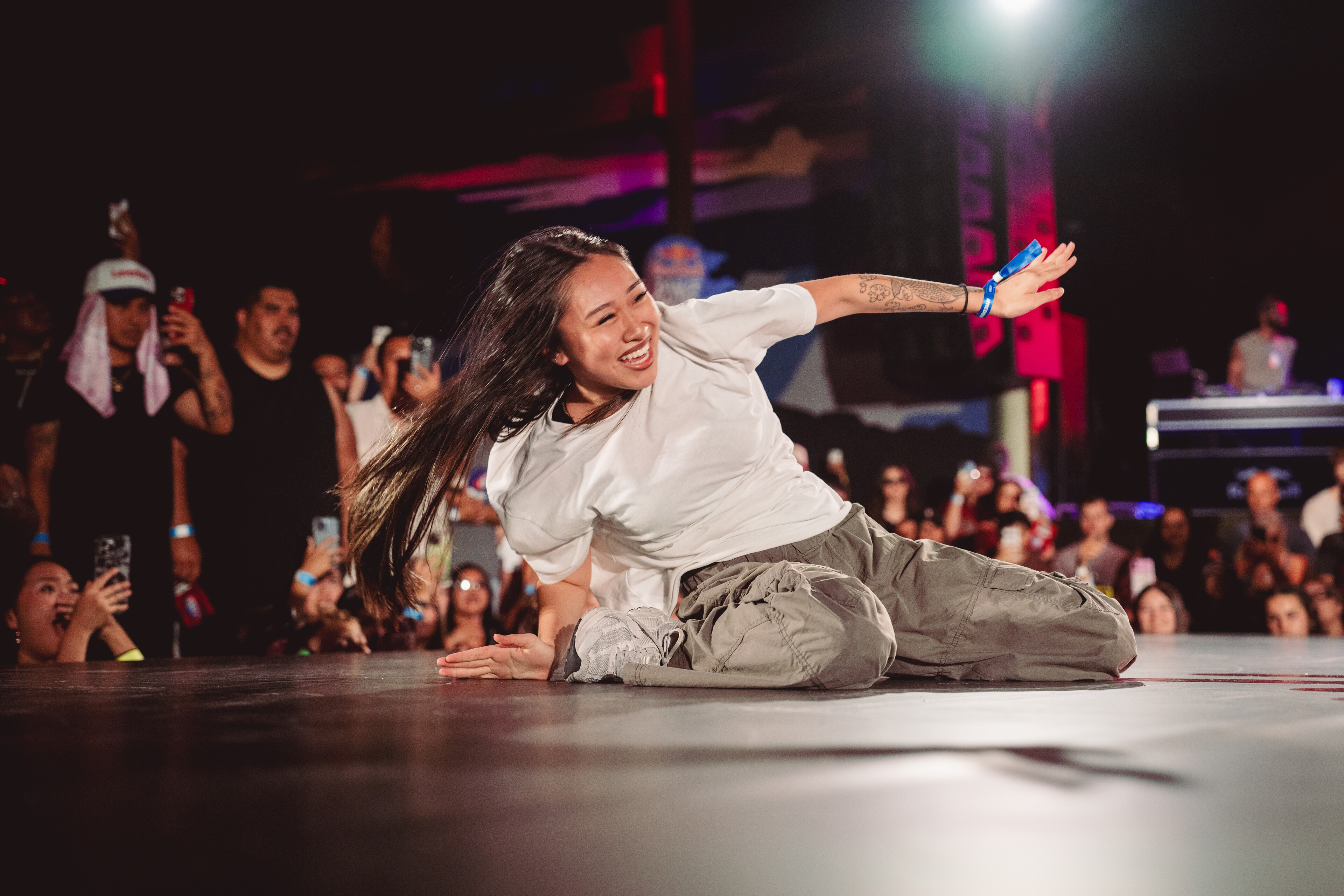 JREAMZ holds the Red Bull Dance Your Style West Qualifier winner trophy in an empty venue after winning the Phoenix regional
