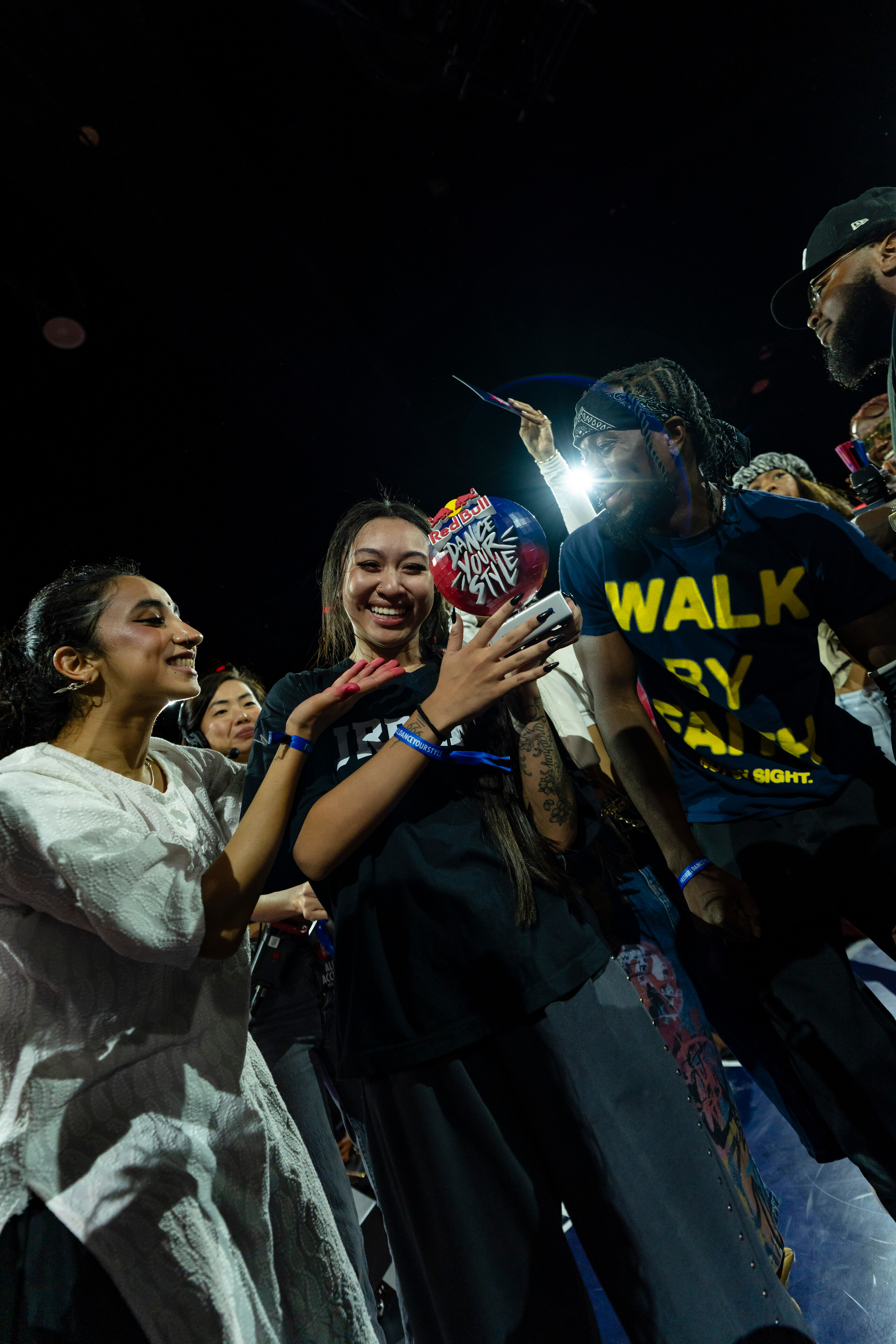 JREAMZ holds the Red Bull Dance Your Style national trophy as fellow competitors crowd around her under falling confetti in Tampa